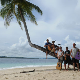 Band under a palm tree.